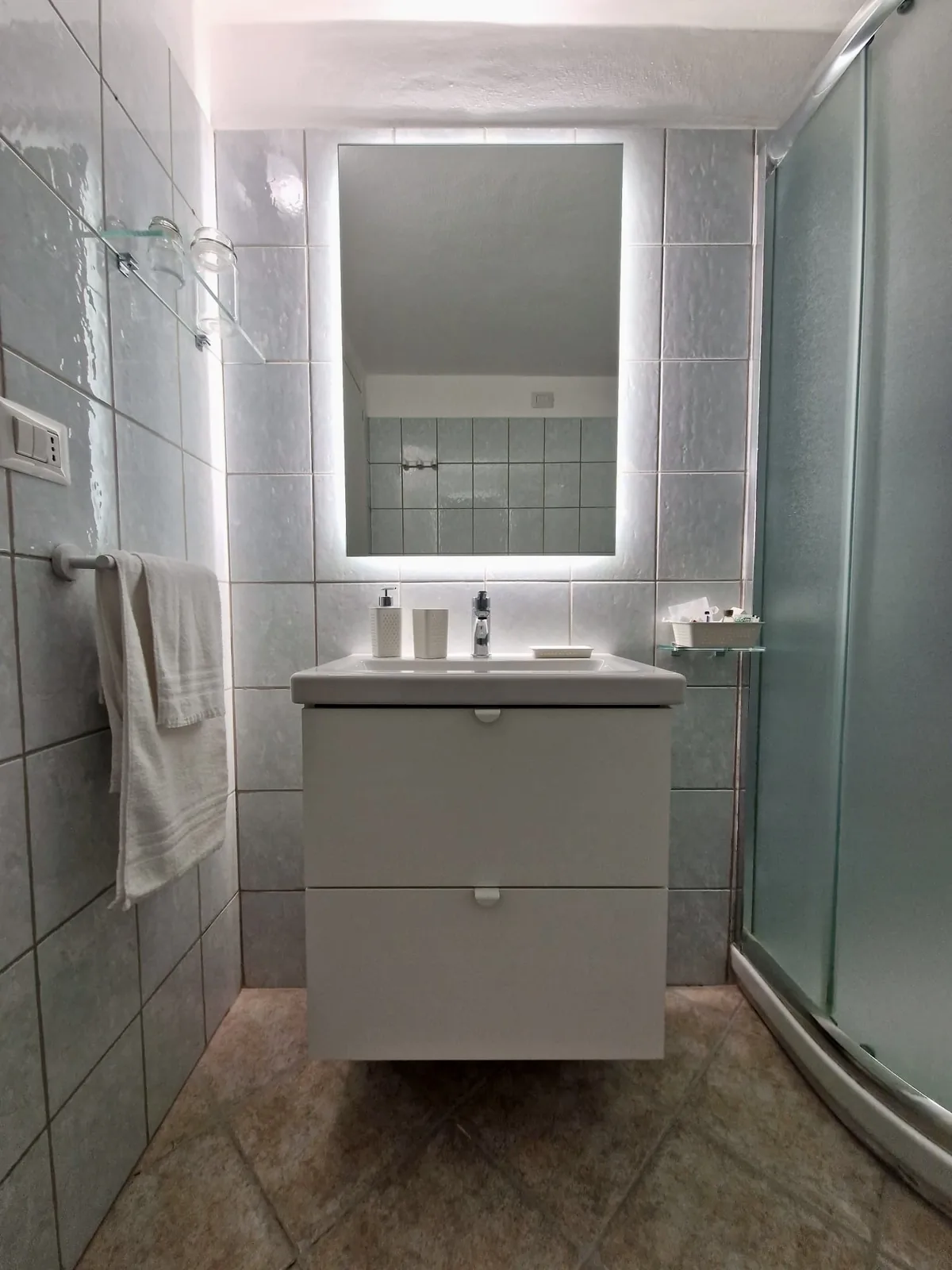 Bathroom with illuminated mirror and shower
