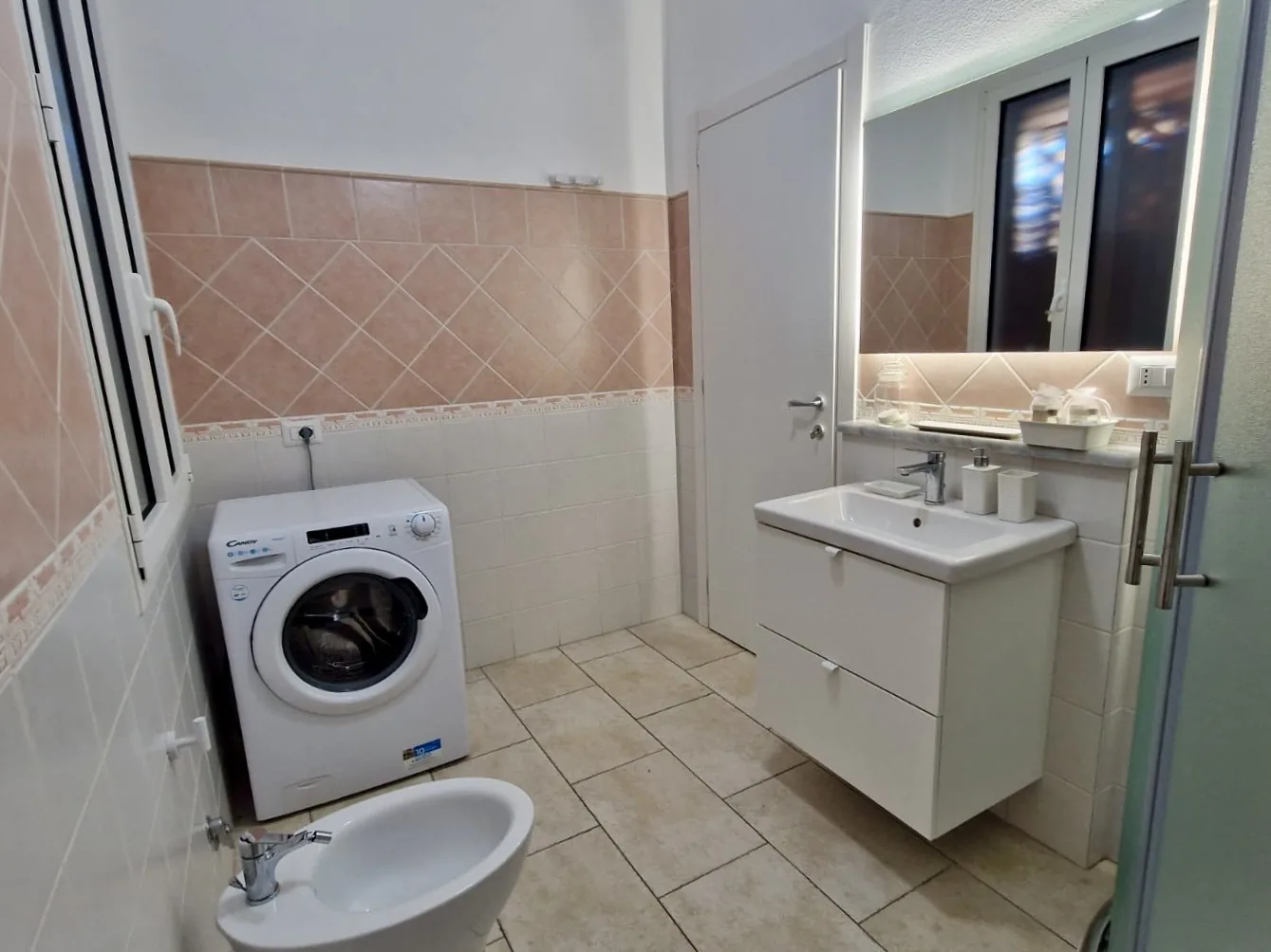 Bathroom with shower, basin and washing machine