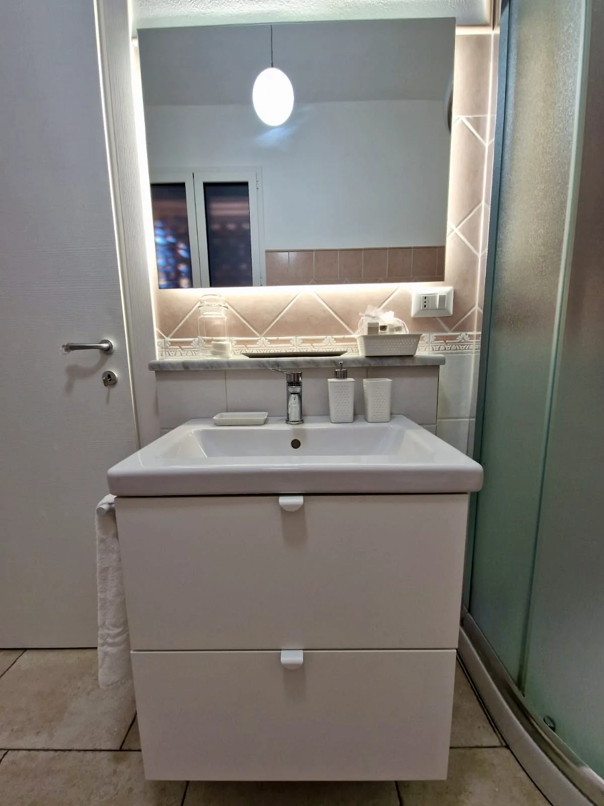 Bathroom with illuminated mirror and shower